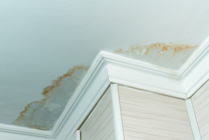 Neighbors have a water leak, water damaged ceiling, close up of a stain on the ceiling